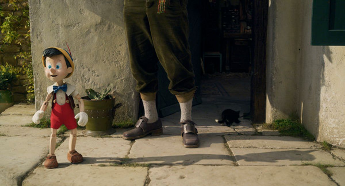 Pinocchio (voiced by Benjamin Evan Ainsworth), Tom Hanks as Geppetto, and Figaro in Disney's live-action PINOCCHIO at 