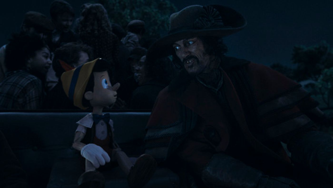 Pinocchio (voiced by Benjamin Evan Ainsworth) and Luke Evans as The Coachman in Disneys live-action PINOCCHIO