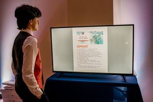 Young performer in the choir Henry Lombardo glancing at the Songlist in the Green Roo Photo