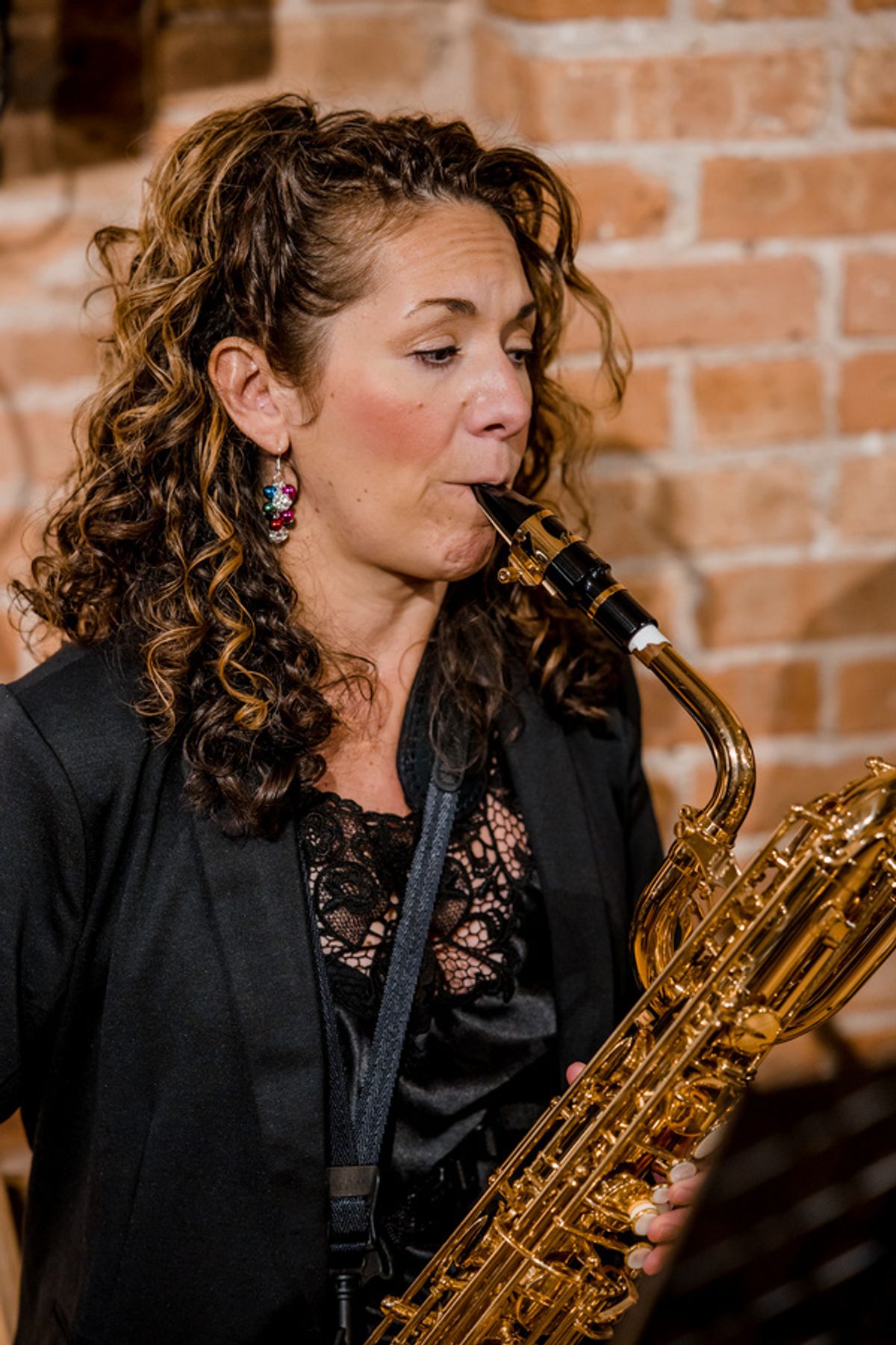 Lara Regan on Baritone Sax. (Photo by Elizabeth Stenholt) at 