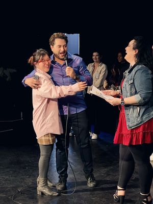 Studio Director & Actor Walid Chaya awards a prize to one of the lucky raffle winners Photo