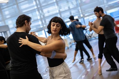 Caleb Marshall Villarreal, Adrienne Balducci, and the company of Evita Photo