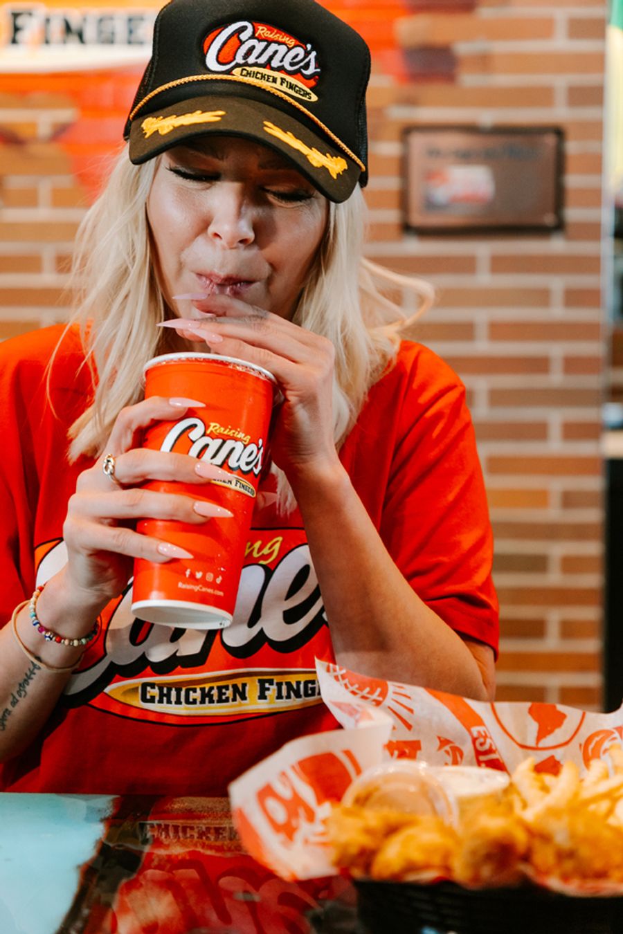 Photos: Ariana Madix Puts Sauce in the #Scandoval, Serves Caniacs at Raising Cane's in El Segundo, CA Image