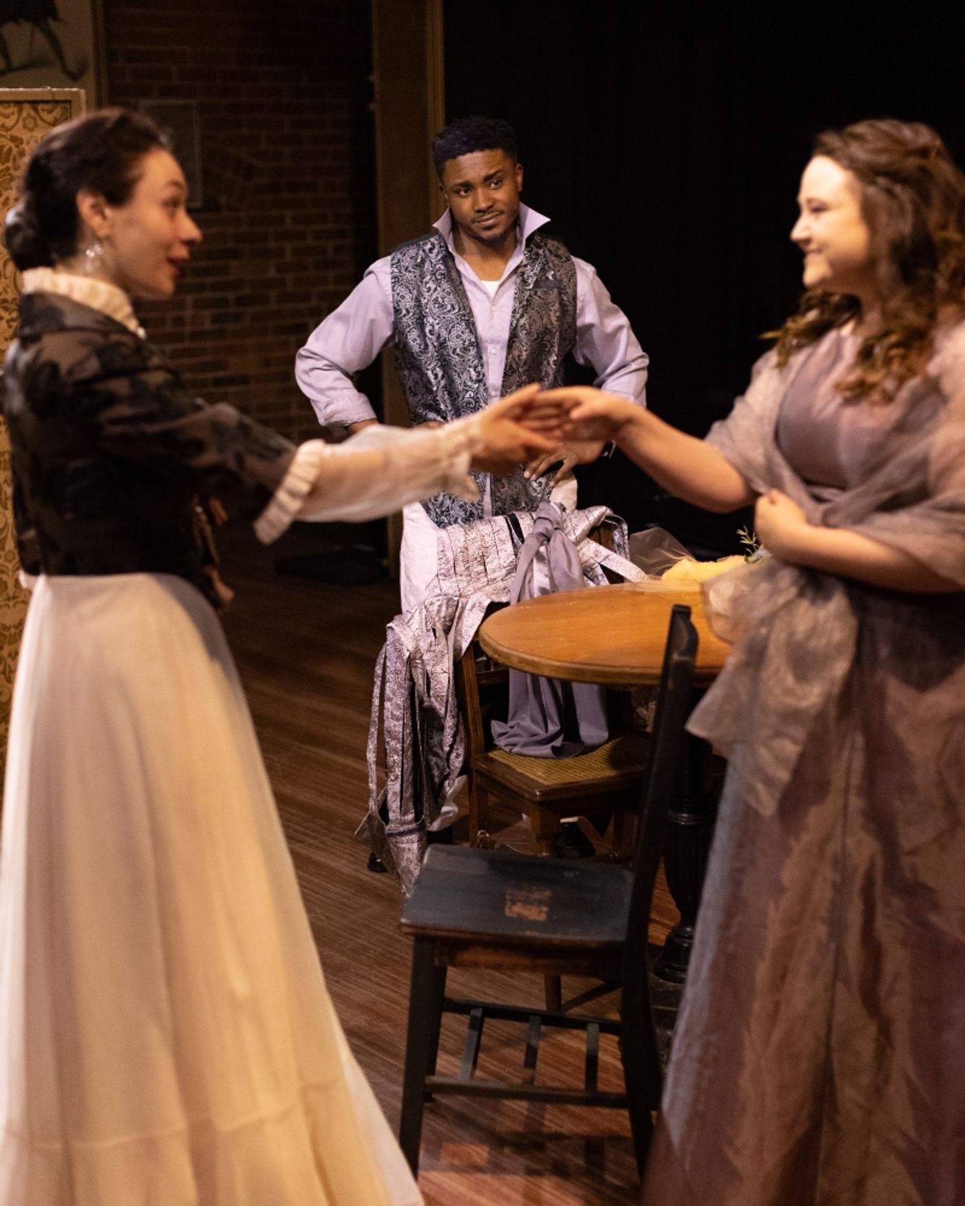 Ellen and Aldridge's wife Margaret hold hands in front of Aldridge.