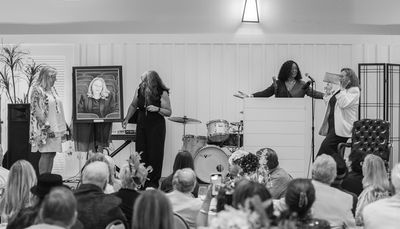 Gloria Banks presents the portrait of Kathy Brombacher. Photo