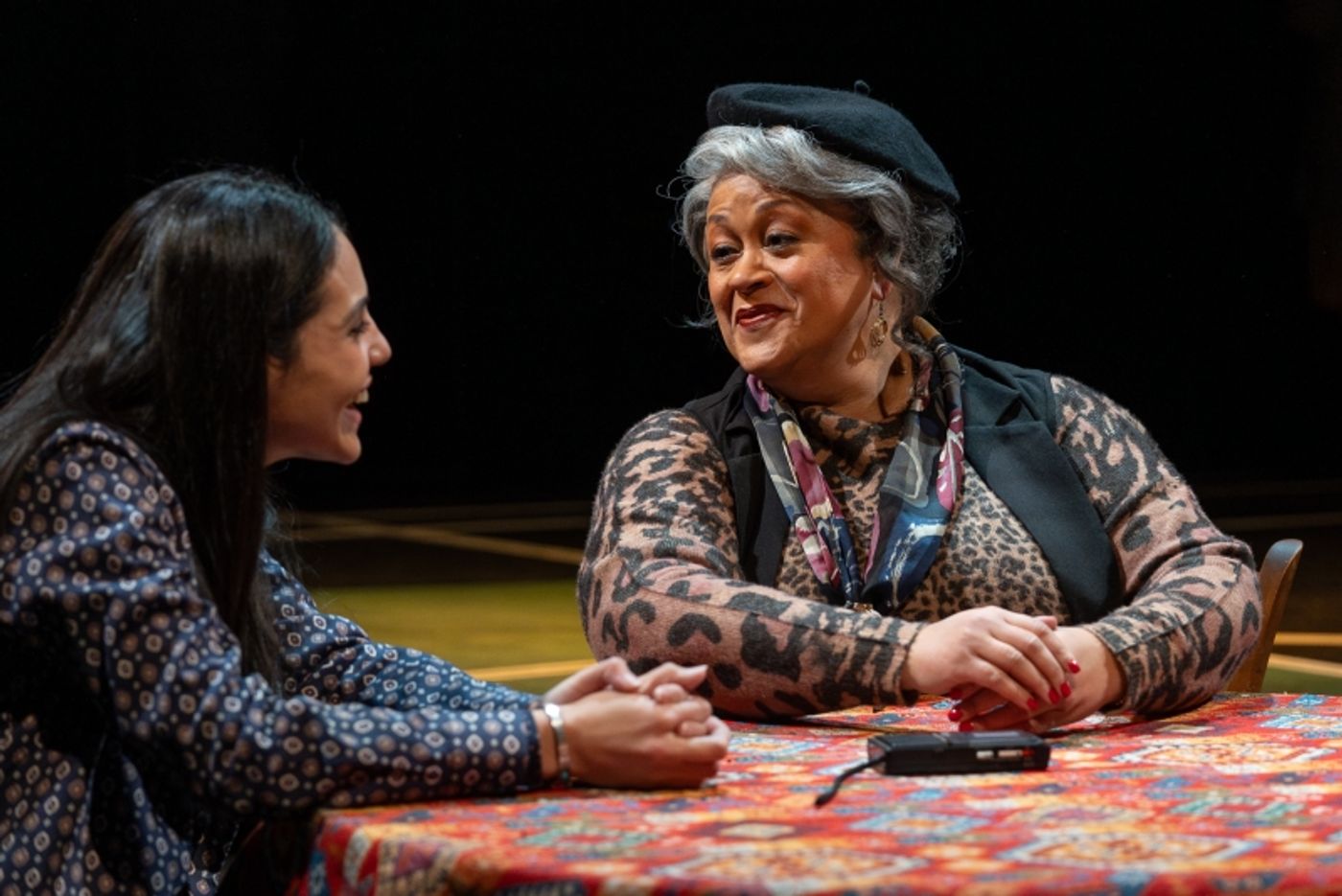 Two women discuss at a table