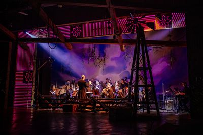 R. Mackenzie Lewis (Conductor/Music Director) and orchestra Photo