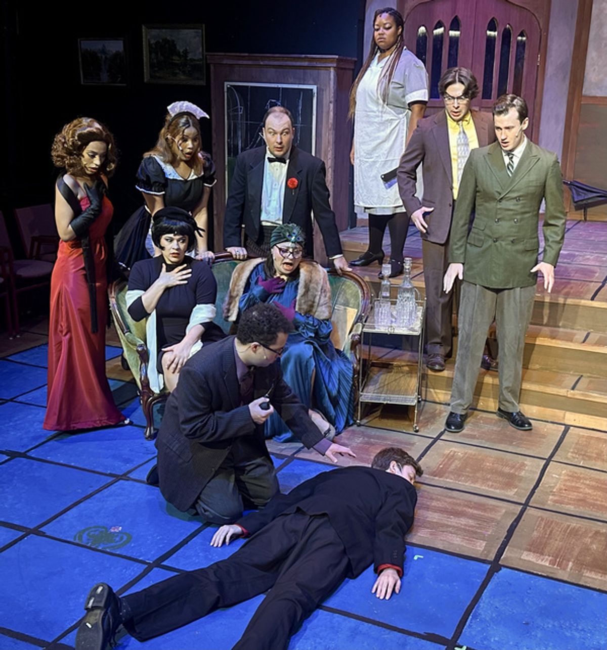 Zayna Darres as Miss Scarlet, Jay'na Johnson as Yvette the Maid, Jackson Pavlik as Wadsworth,  Shantel Hill as Cook (on step), John Murphy as Colonel Mustard, Adam Forward as Mr. Green, (Seated) Kali Haines as Mrs. White, Marissa Budnick as Mrs. Peacock, Dylan Henderson as Professor Plum (on ground) Adam Fox at 