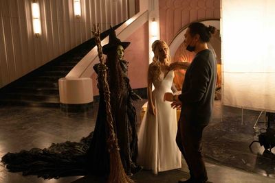 L to R: Cynthia Erivo (as Elphaba), Ariana Grande (as Glinda), and Director Jon M. Ch Photo