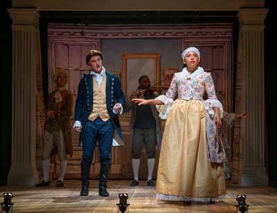 Adam KuveNiemann) looks at Sally Hemings (Emily Newsome) as Cooper (background - Mich Photo