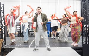 Sam Lupton (Centre) & The cast in rehearsals for BANK OF DAVE, credit Marc Brenner Photo
