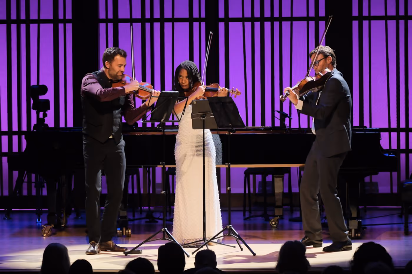 Three violinist on stage