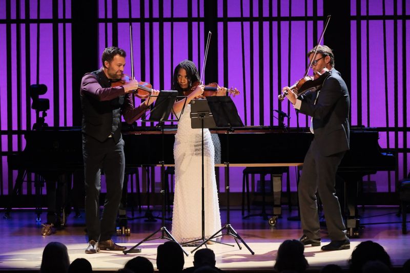 Three violinist on stage