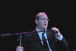 Neil Berg thanking the audience for being part of the fundraiser Photo