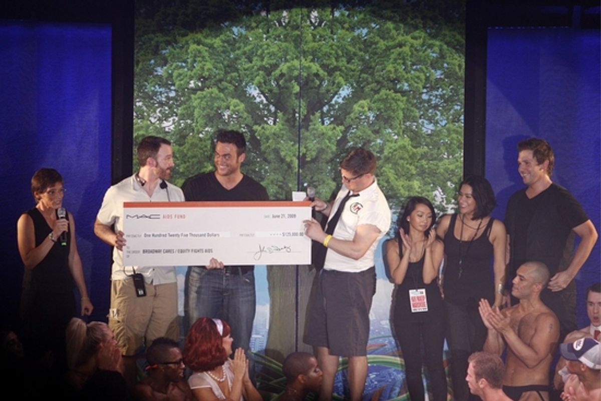 Nancy Mahon from MAC AIDS Fund and BC/EFAÃ¢â‚¬â„¢s Michael Graziano present a check to Cheyenne Jackson and Christopher Seiber at 