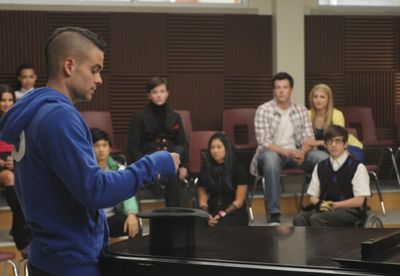 Puck (Mark Salling, L) picks his singing partner's name from a hat Photo