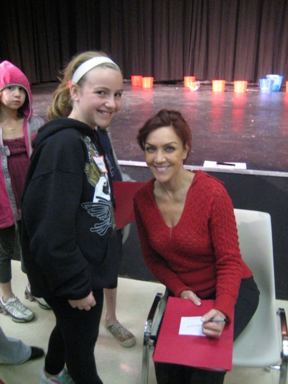 Andrea McArdle signs autographs for students at 