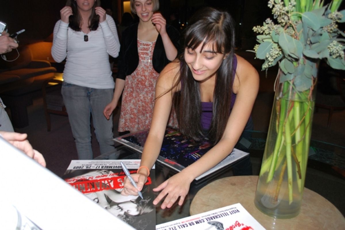 Krystina Alabado signs posters at 