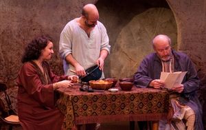 Wife Ambara (Suehyla El-Attar) and husband Yusef (Demosthenes Chrysan) discuss rebellion against British rule with their friend Hajj Waleed (Tom Thon). @ BroadwayWorld Wife Ambara (Suehyla El-Attar) and husband Yusef (Demosthenes Chrysan) discuss rebell Photo