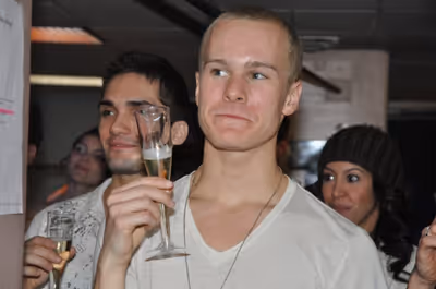 Ryan Steele raises his champagne  Photo