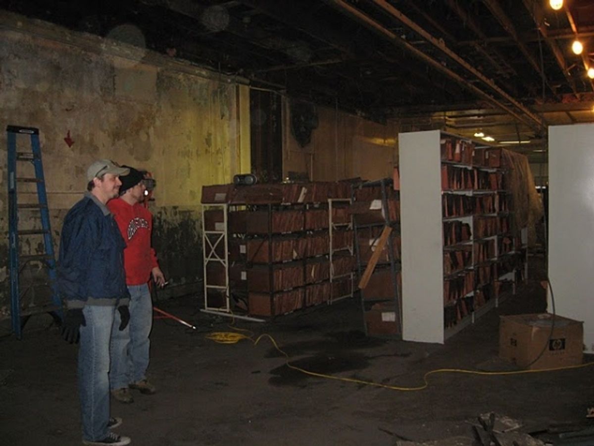 Josh Kessler, Andy Batt survey the previous owner's files at 