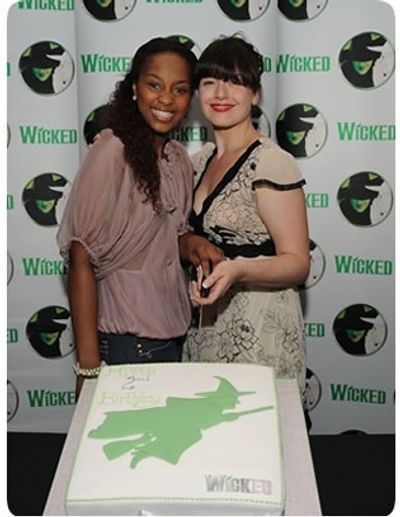 Alexia Khadime and Dianne Pilkington cut the cake at Wicked's birthday party Photo