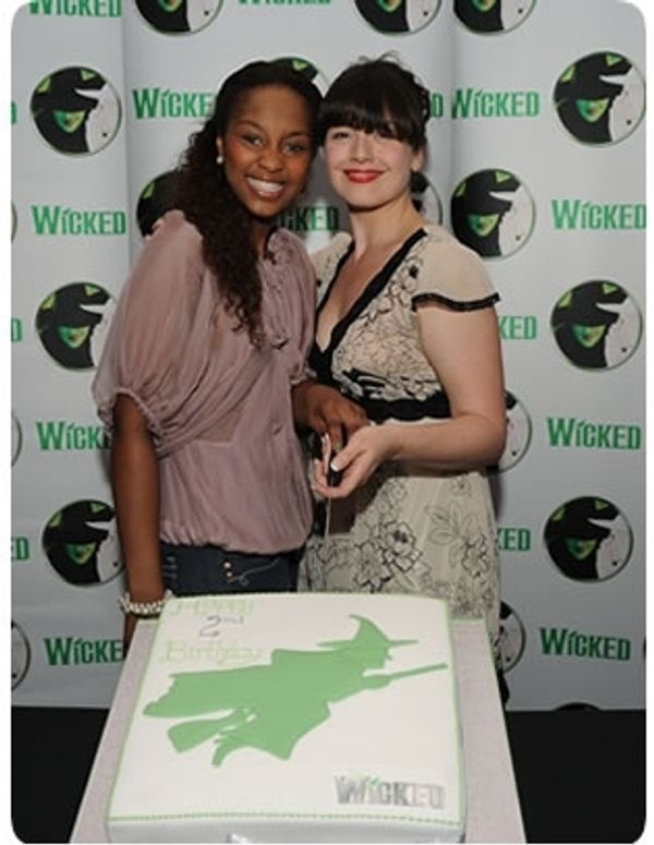 Alexia Khadime and Dianne Pilkington cut the cake at Wicked's birthday party Photo