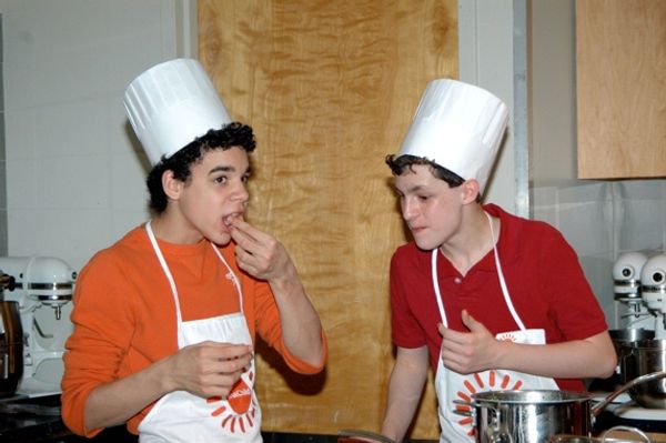 Trent Kowalik and David Alvarez sampling their cooking Photo