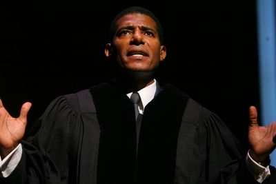  	  James (Billy Eugene Jones) is shown preaching to his congregation during the mids Photo