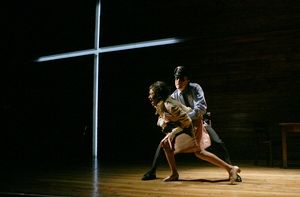 Claudette (Nambi E. Kelley) struggles to free herself from a police officer (John Hoo Photo