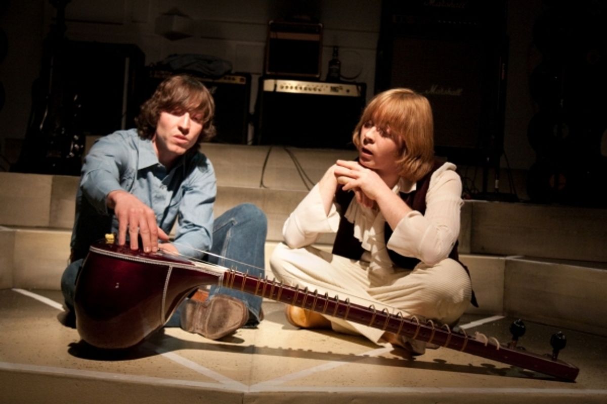 George (Andrew Yearick) introduces Brian (AaRon Snook) to the sitar at 