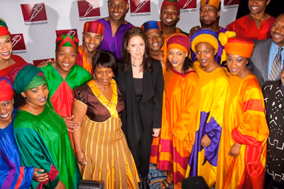 Julie Taymor with the cast of the Lion King Photo