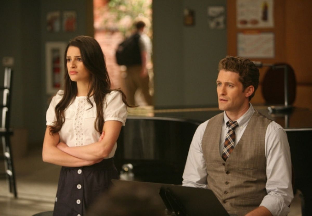 Rachel (Lea Michele, L) shares some news with Will (Matthew Morrison, R) and the glee club at 