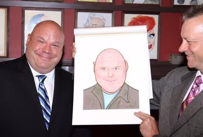 Max Klimavicius presents Kevin Chamberlin with his new caricature! Photo