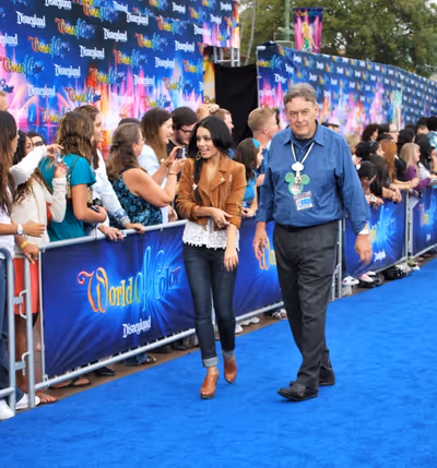 Vanessa Hudgens is escorted down the blue carpet Photo