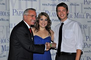 Mark S. Hoebee and Christine Danelson congratulation the winner of a dance contest fo Photo