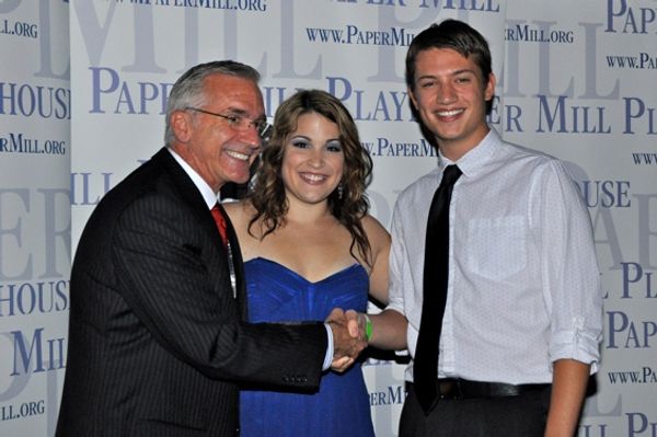 Mark S. Hoebee and Christine Danelson congratulation the winner of a dance contest fo Photo