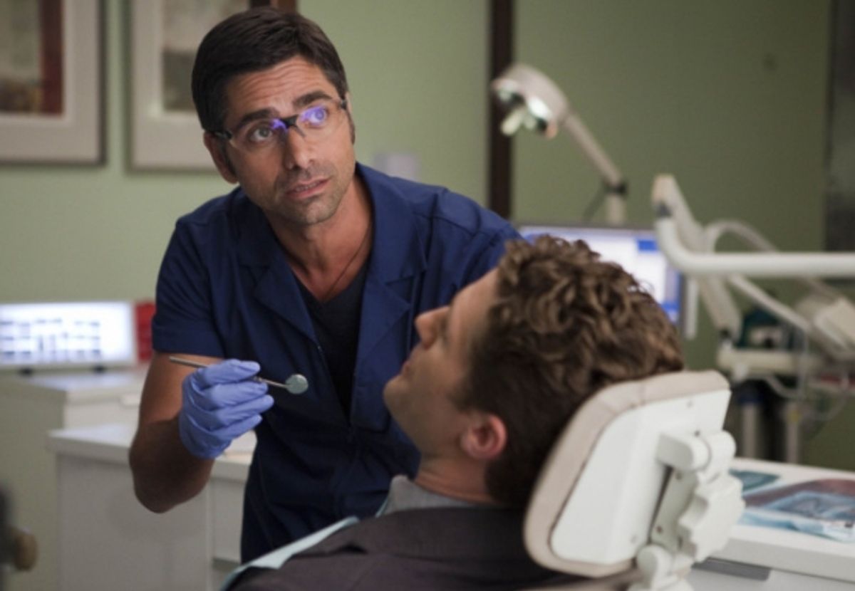 Dr. Carl (guest star John Stamos, L) checks out Will's (Matthew Morrison, R) dental hygiene at 