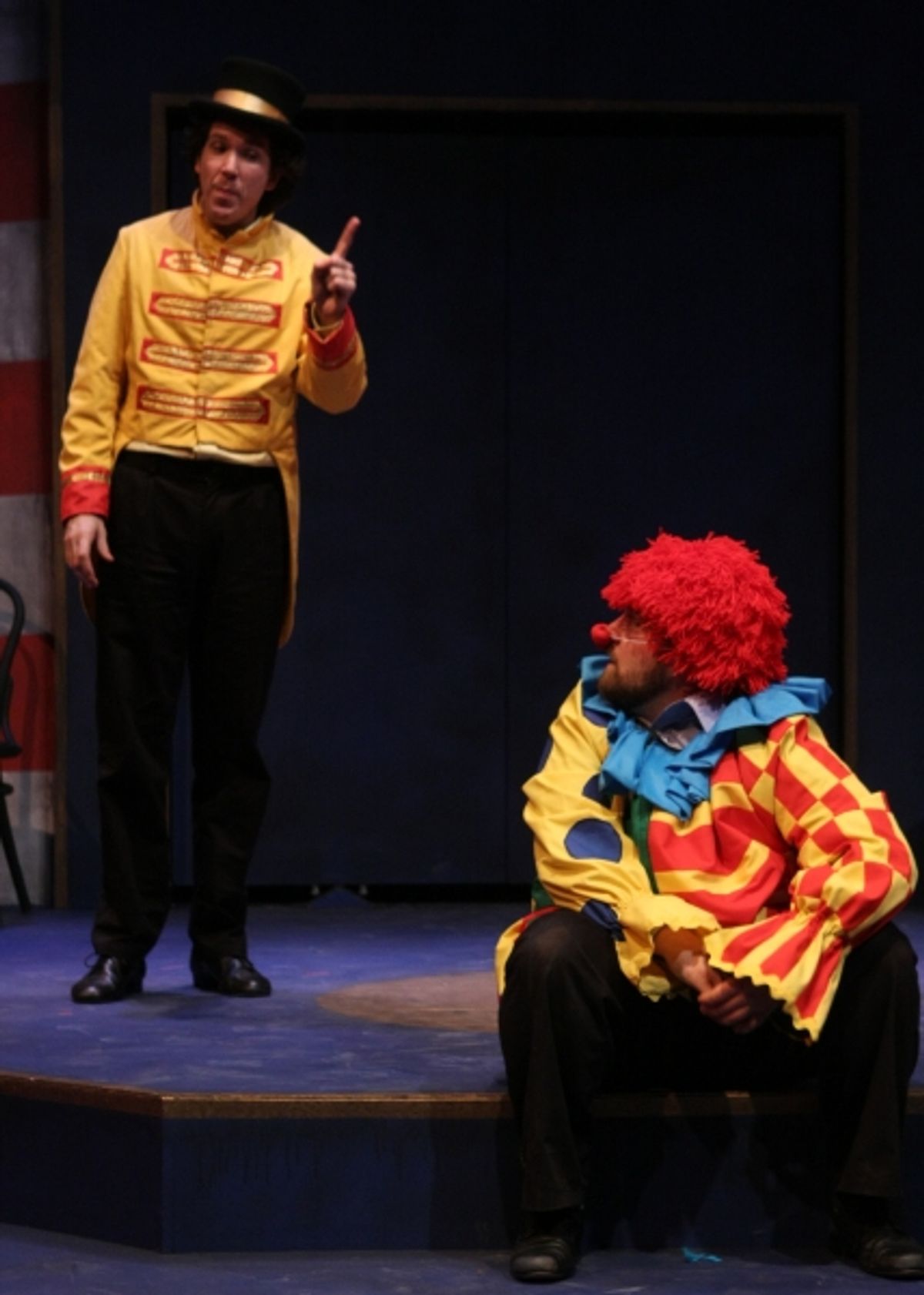 Beppo the clown (Matt Erkel) gets scolded by The Ringmaster (Paul de Cordova) for causing trouble in town. at 