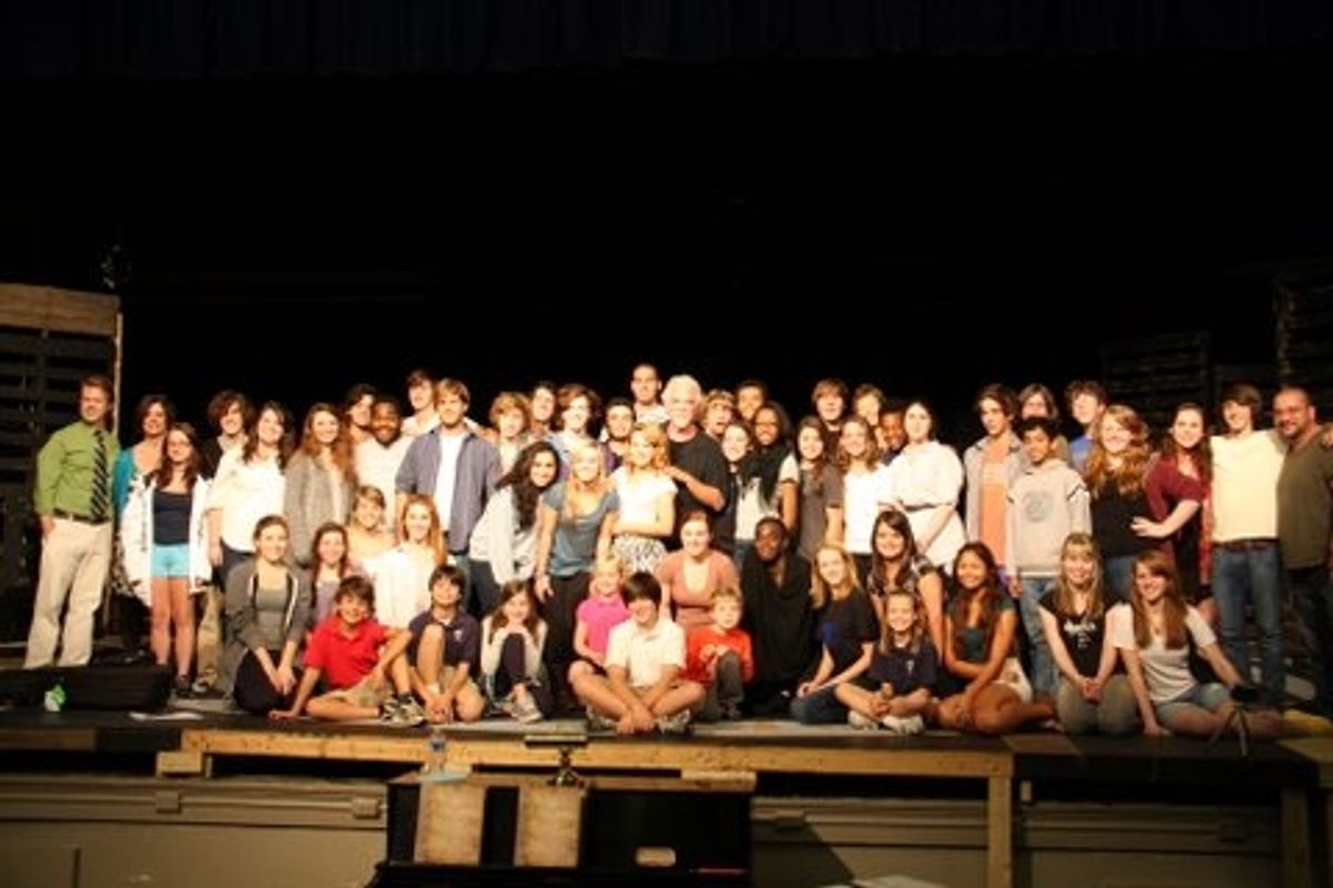 Gary Morris poses for a photo with the 50-member cast of Hume-Fogg Academic High School's production of Les Miserables at 