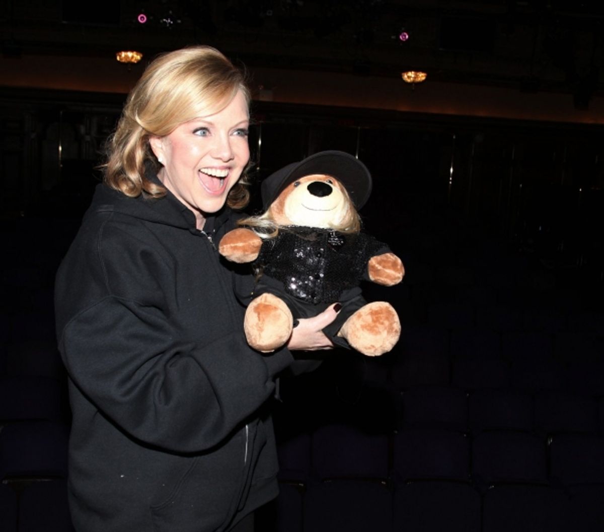 Susan Stroman poses with a bear in her likeness, a gift from Clinton Roane at 