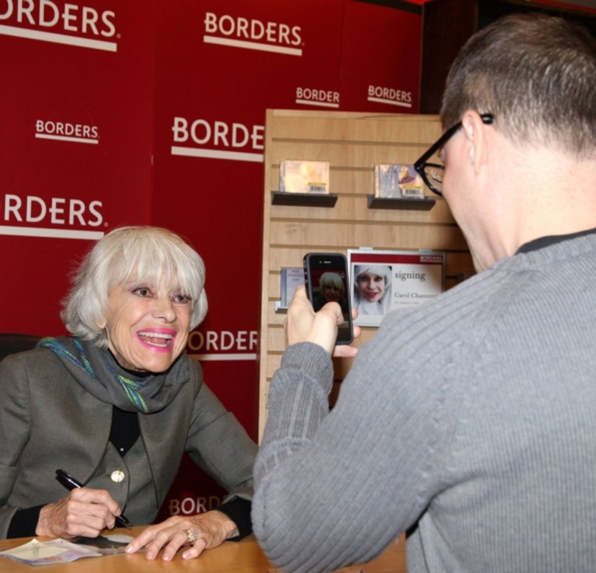 Carol Channing posing for a fan at 
