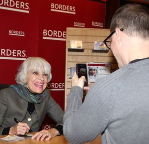 Carol Channing posing for a fan Photo