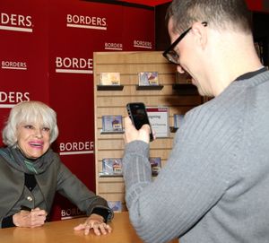 Carol Channing posing for a fan Photo