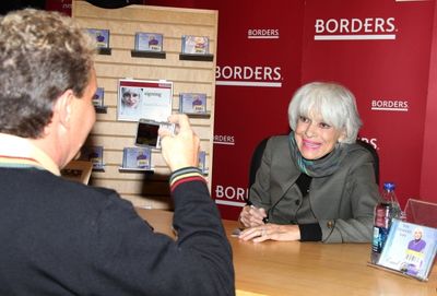 Carol Channing posing for a fan Photo