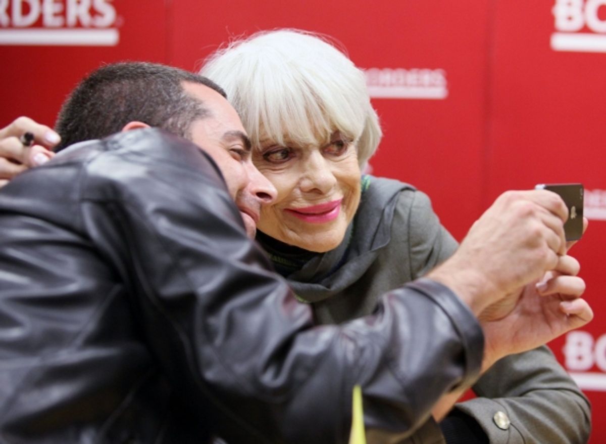 Carol Channing posing for a fan at 