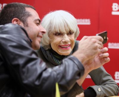 Carol Channing posing for a fan Photo