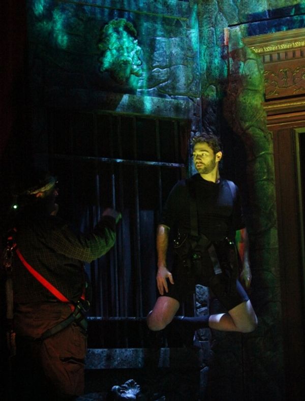 John Buffalo Mailer is practicing wall climb during the Tech Rehearsal Photo