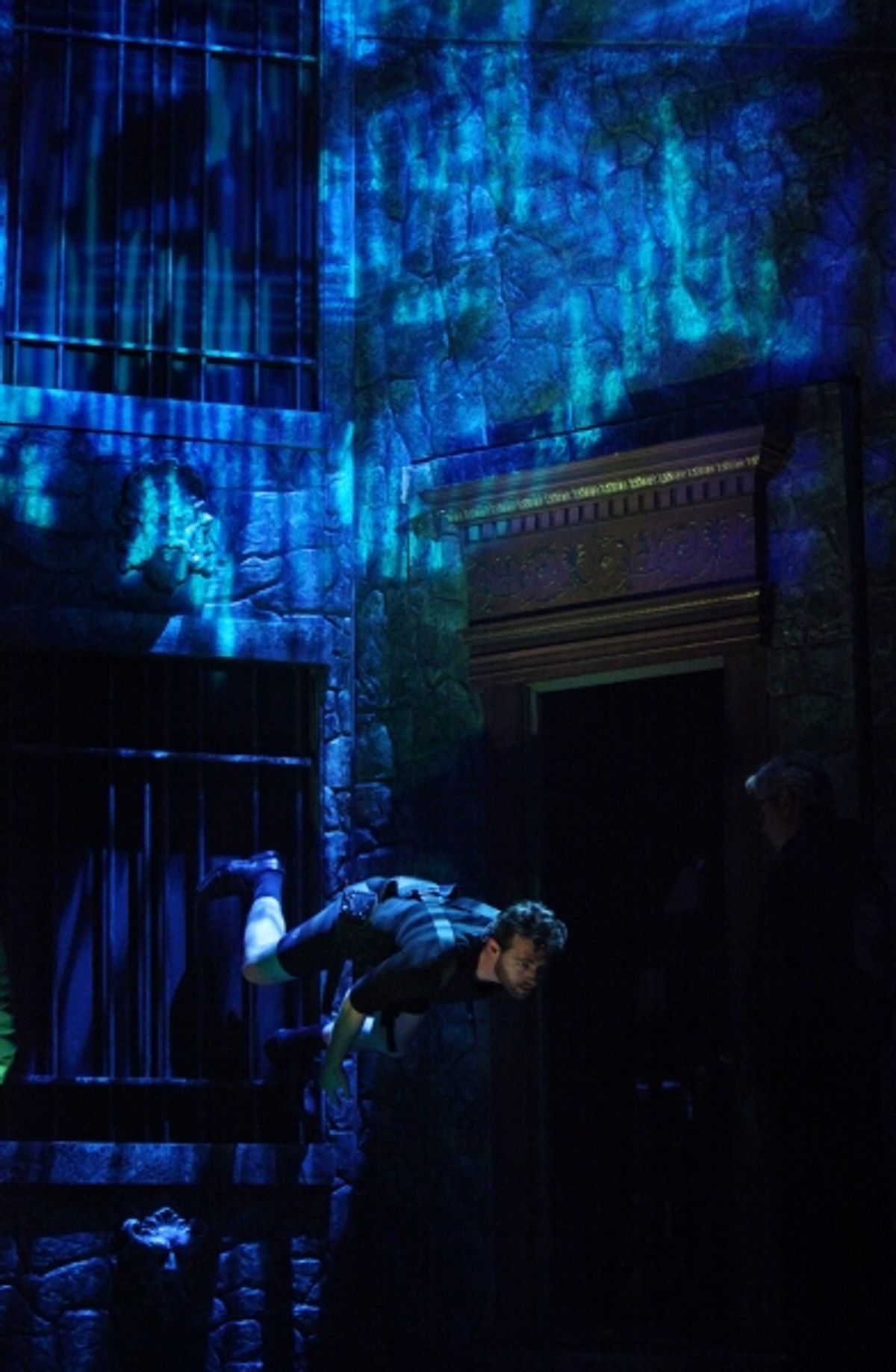 John Buffalo Mailer is practicing wall climb during the Tech Rehearsal at 