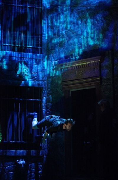 John Buffalo Mailer is practicing wall climb during the Tech Rehearsal Photo